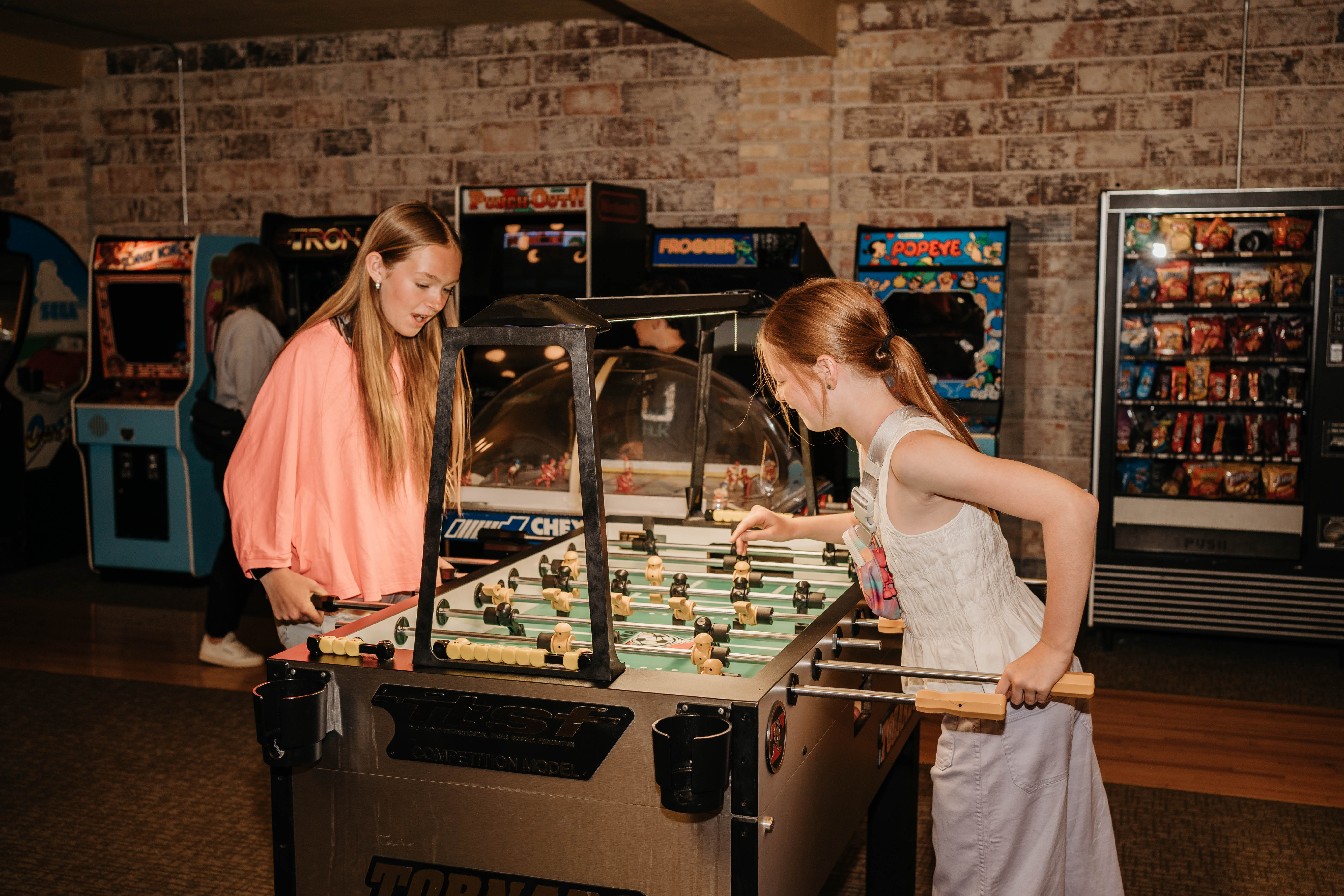 Arcade with children playing foosball