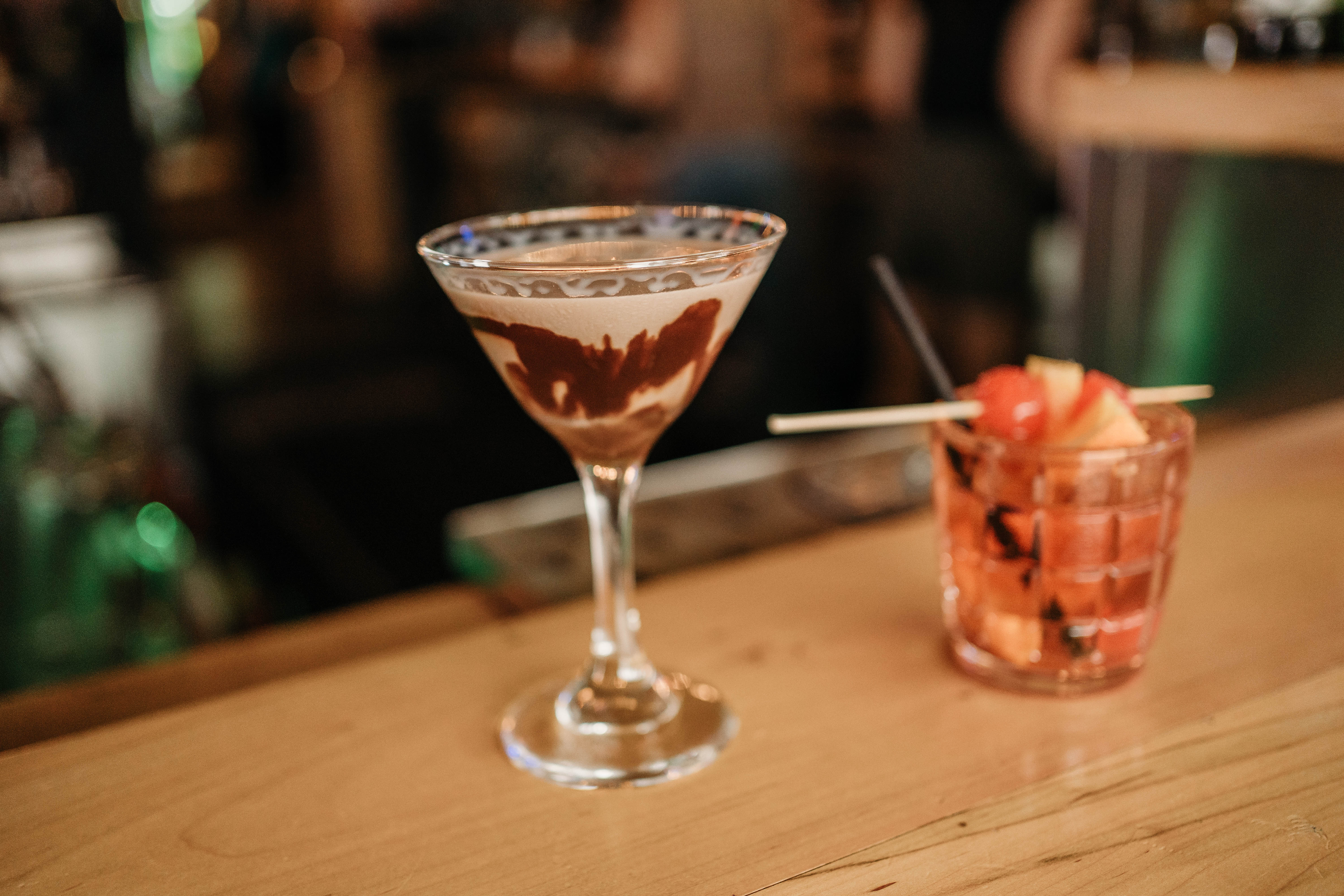 Martini and Wisconsin Old Fashion sitting on a wooden bar