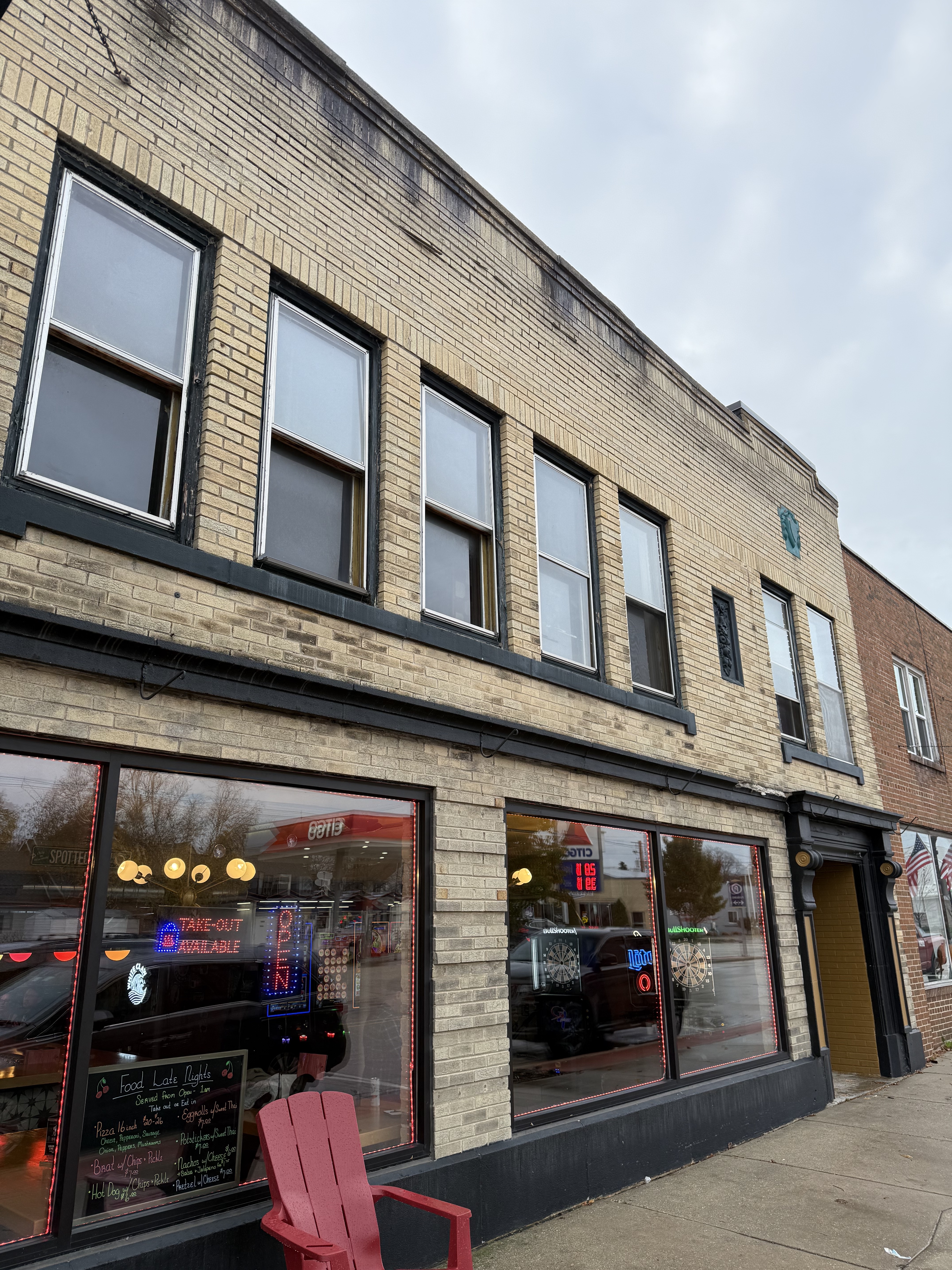 Outside of Cherry Lanes Arcade Bar located on 4th Avenue in Sturgeon Bay. Two Story cream brick building.